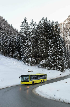 Bus fährt durch verschneite Landschaft