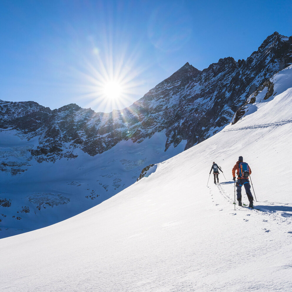 Skitourengeher:inne auf der Traverse Richtung Ödenwinkelkees bei strahlendem Sonnenschein
