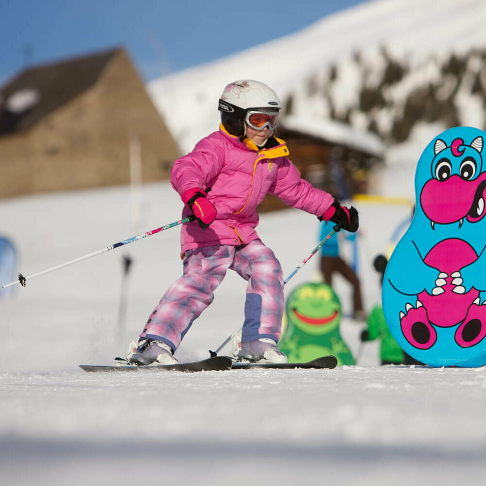 Kind fährt am Zettersfeld durch lustige Figuren