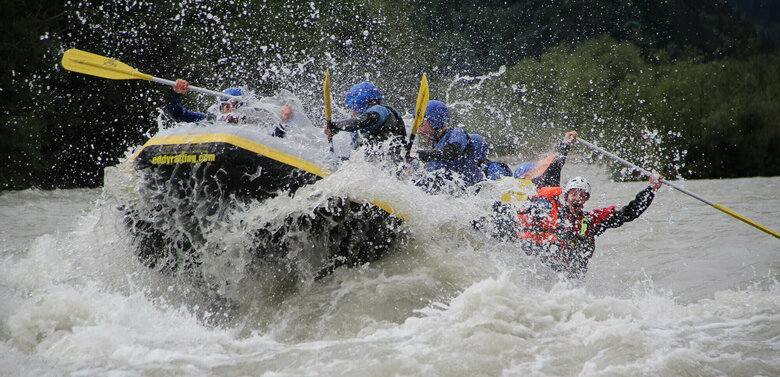 Eine Gruppe Personen sitzt in einem Schlauchboot auf einem reißenden Fluss in Osttirol.