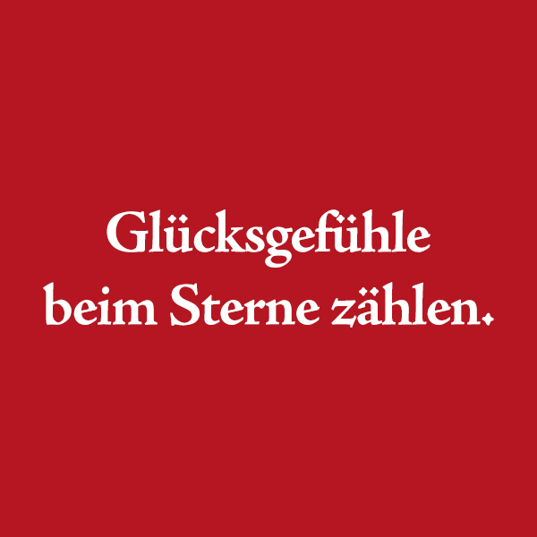 Roter Hintergrund mit dem weißen Schriftzug "Glücksgefühle beim Sterne zählen"